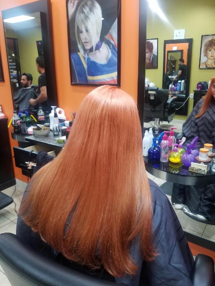 Long copper-colored hair styled smooth after a color service