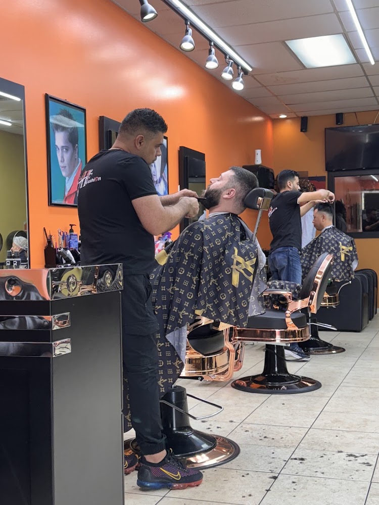 Barber shaping a client's beard at Hair Fashion Salon